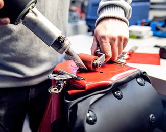 Man repairing a bike bag